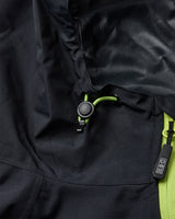 Close-up of a navy jacket with green zipper and brand logo.
