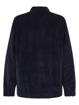 A dark navy blue corduroy jacket shown from the back, featuring a classic collar and long sleeves with button cuffs, set against a plain white background.