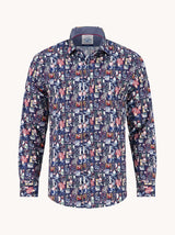 A long-sleeve button-up shirt with an all-over cartoon character print in navy blue, red, white, and light blue, shown on a plain off-white background.