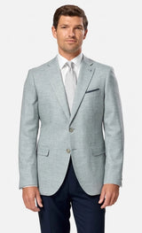 Man wearing a light green suit with a white shirt and tie on a white background
