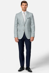Man wearing a light green blazer, white shirt, and dark blue pants on a white background