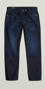 Pair of dark blue jeans on a light gray background