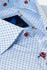 Close-up of a light blue patterned dress shirt with small red and navy dots, a floral print collar, and a dark navy neck label reading ETTI.
