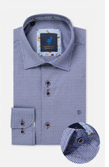 A folded men's dress shirt by Montecci, featuring a blue and white micro-check pattern with a floral print lining on the collar and cuffs. A circular inset in the bottom right corner highlights the detailed cuff construction.