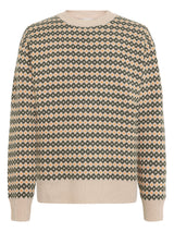 A long-sleeve crewneck sweater featuring a repeating geometric diamond pattern in dark gray, beige, and orange, with solid beige ribbed trim at the collar, cuffs, and hem.