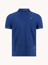Blue polo shirt with small embroidered design on a white background