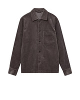 A dark grey corduroy utility jacket with a button-up front, collar, and a chest pocket, shown flat on a white background.
