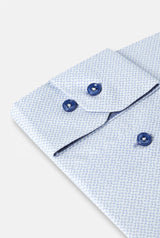Close-up of a light blue textured shirt with buttons on a white background