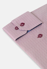 Pink patterned shirt with matching cufflinks on a light gray background