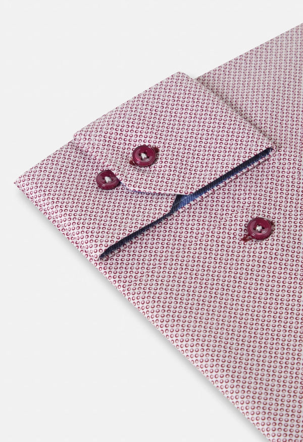 Pink patterned shirt with matching cufflinks on a light gray background