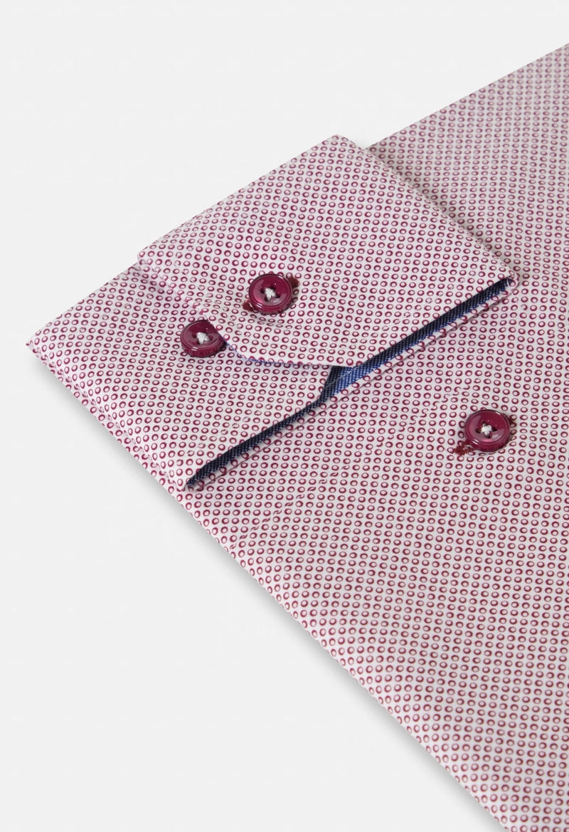 Pink patterned shirt with matching cufflinks on a light gray background