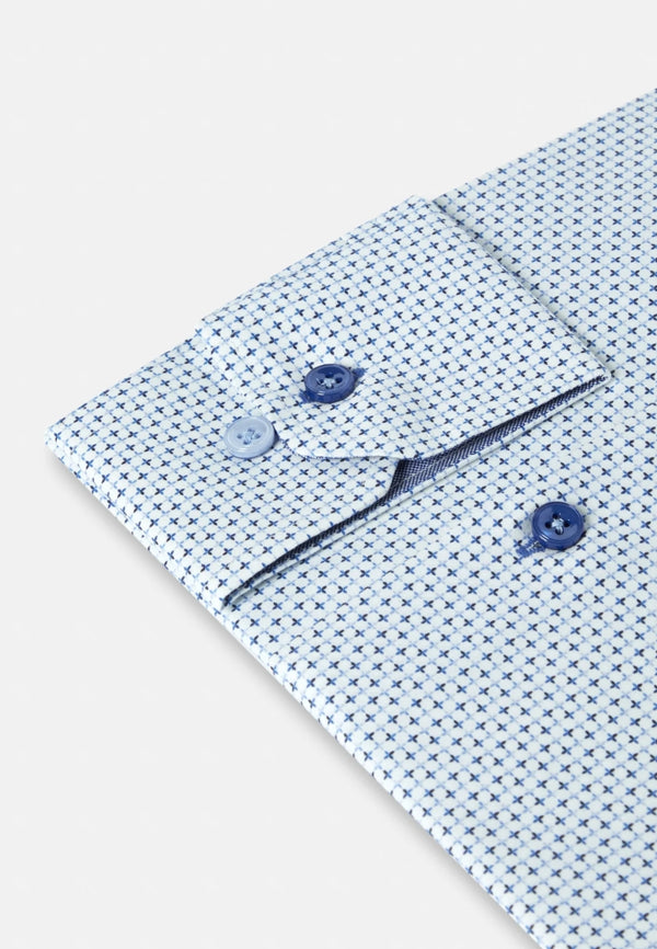 Close-up of a patterned shirt with buttons on a light background