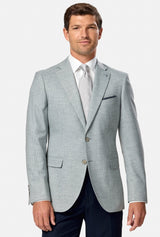 Man wearing a light green checkered blazer over a white shirt with a tie on a white background