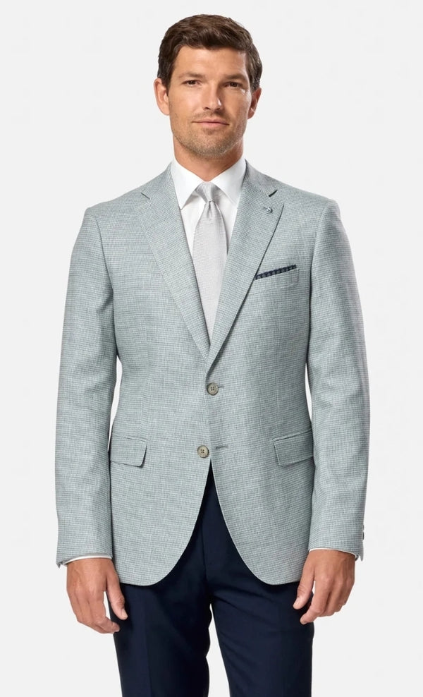 Man wearing a light green suit with a white shirt and tie on a white background