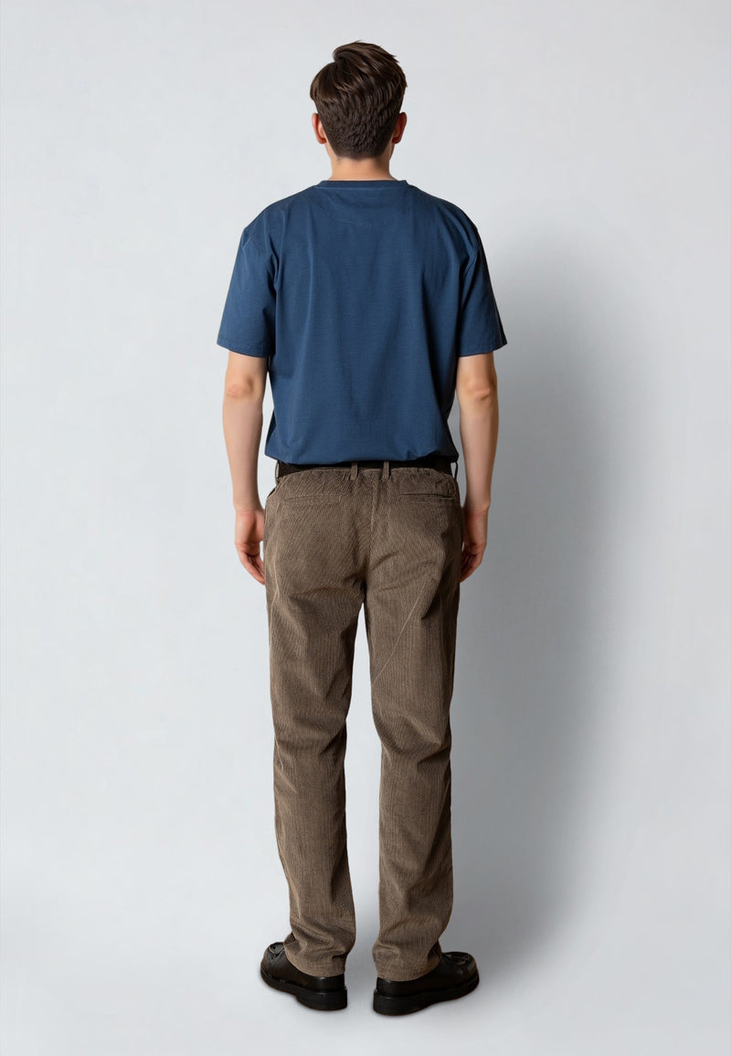 Person wearing a blue shirt and brown pants against a white background