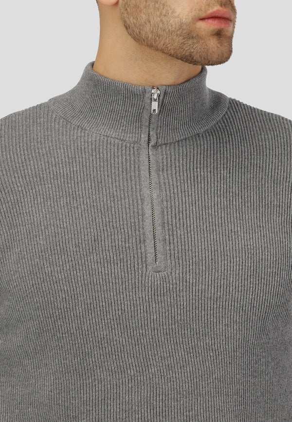 Gray ribbed sweater with a quarter zip on a plain background