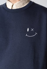 Navy blue sweatshirt with a white smiley face design on a plain background