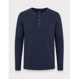 A dark navy blue long-sleeve henley shirt with three buttons on the chest, displayed on a neutral light gray background.