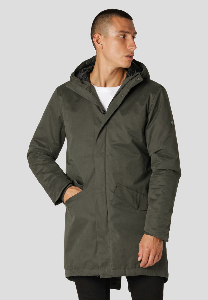 Man wearing a green raincoat on a light gray background