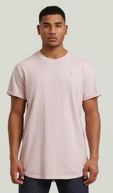 Man wearing a lilac t-shirt against a plain background
