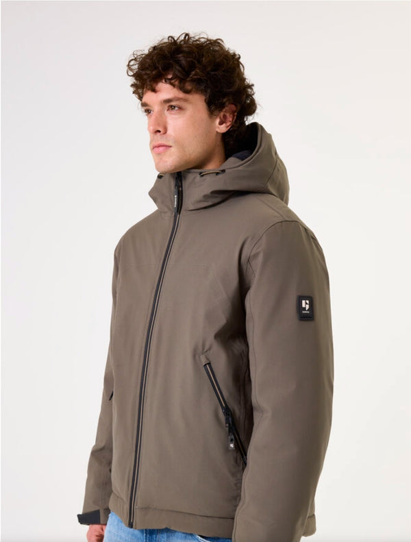 Man wearing a green jacket with a hood on a white background