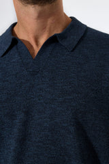 Navy blue polo shirt worn by a person on a white background