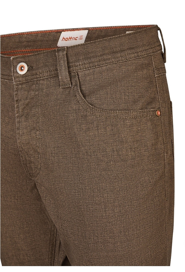 Brown pants with a brand label on a white background