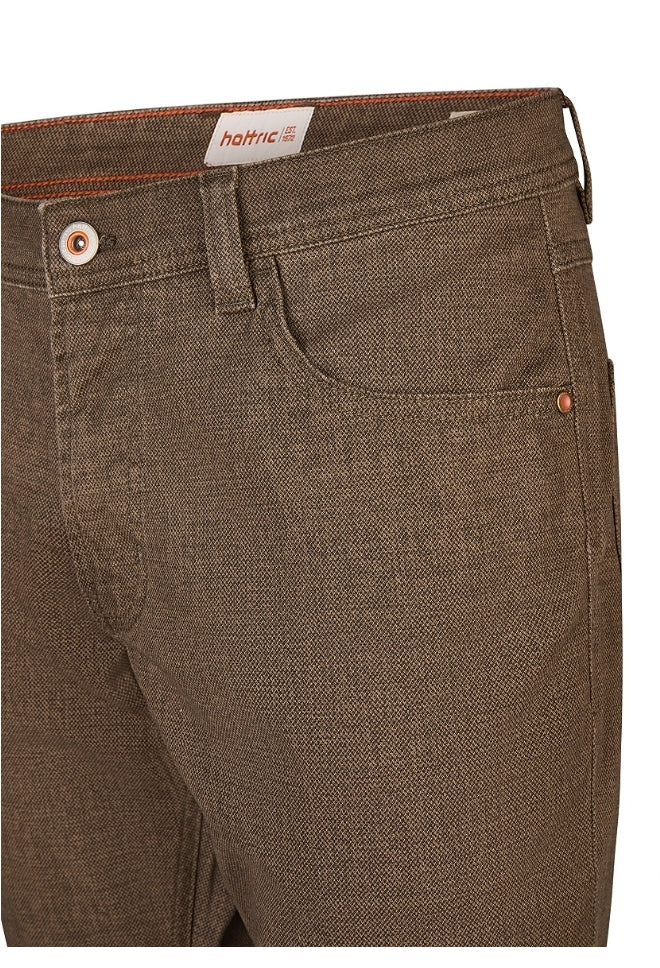 Brown pants with a brand label on a white background
