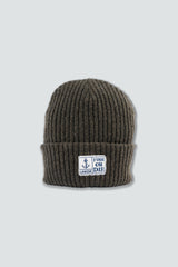 Olive green knit beanie with a logo on a light gray background