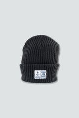 Navy knit beanie with a logo on a light gray background