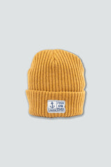 Yellow beanie with a logo on a light gray background