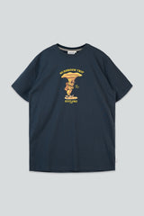 A navy blue short-sleeve t-shirt with a yellow and gold graphic on the chest depicting a mushroom and the text 'MUSHROOM TRIP' and 'KAYUMI', shown flat against a light gray background.