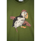 An olive green crewneck t-shirt featuring a large graphic of a puffin with a pirate hat, skull and crossbones, and anchor motifs on its body, with pink wings and an orange beak.