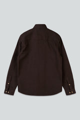 A dark brown long-sleeve button-up shirt shown from the back, featuring a pointed collar and buttoned cuffs, laid flat against a light gray background.