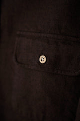 Close-up of a button on a dark fabric background