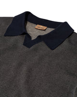 Close-up of a dark blue collar on a textured shirt with a brand label.