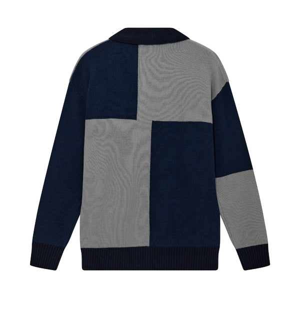 Color-blocked sweater with navy and gray pattern on a white background