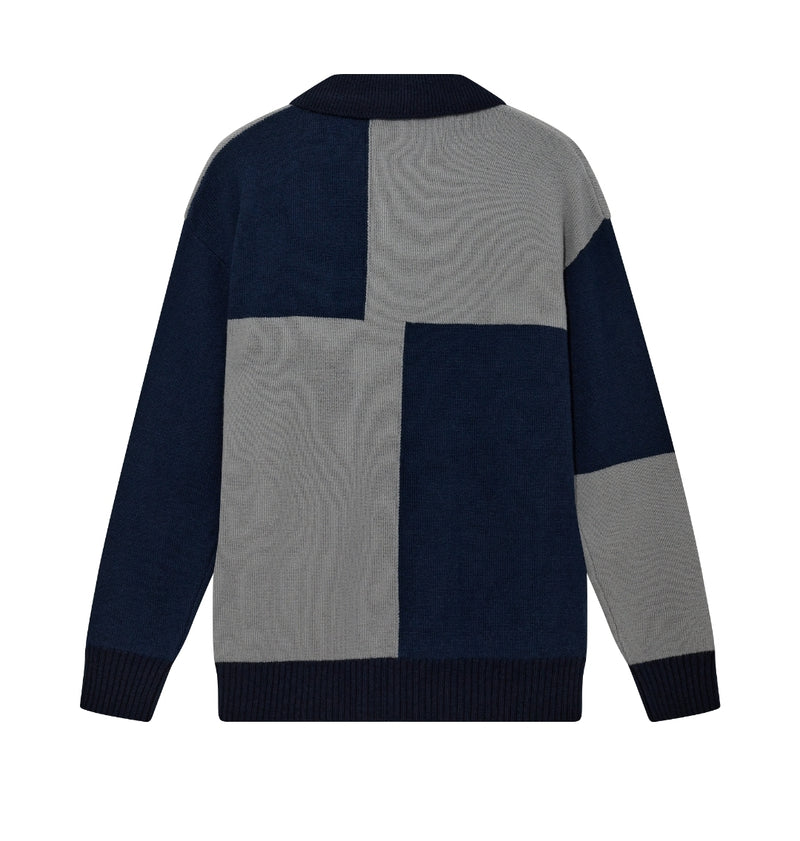 Color-blocked sweater with navy and gray pattern on a white background