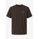 A dark brown short-sleeve crewneck t-shirt with a small white smiley face graphic on the left chest, displayed against a light gray background.