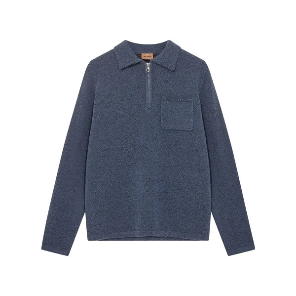 Blue long-sleeve shirt with a collar and pocket on a white background